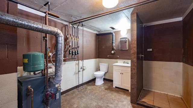 bathroom featuring a shower, toilet, and vanity