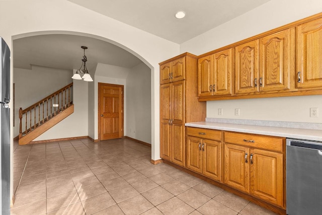 kitchen with decorative light fixtures, light tile patterned floors, appliances with stainless steel finishes, and an inviting chandelier