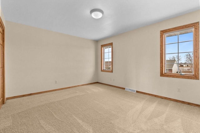 unfurnished room featuring carpet flooring