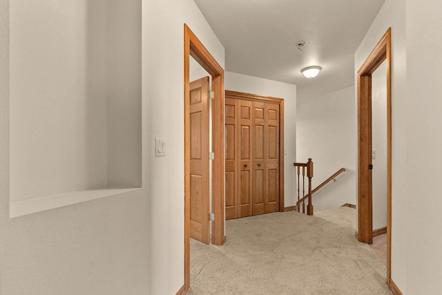 corridor featuring light colored carpet