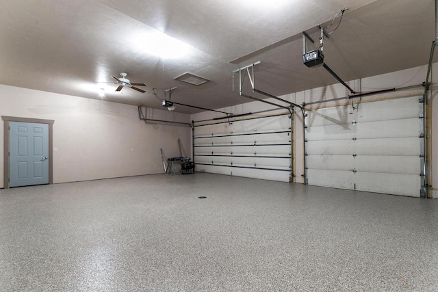 garage featuring ceiling fan and a garage door opener