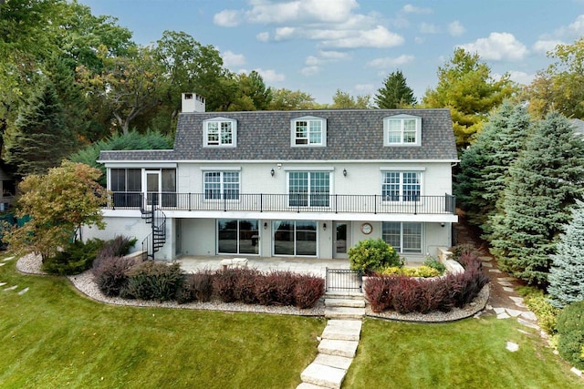 view of front of home with a patio area, a front lawn, and a sunroom