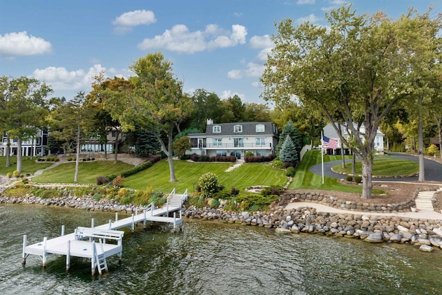 view of dock with a water view and a yard