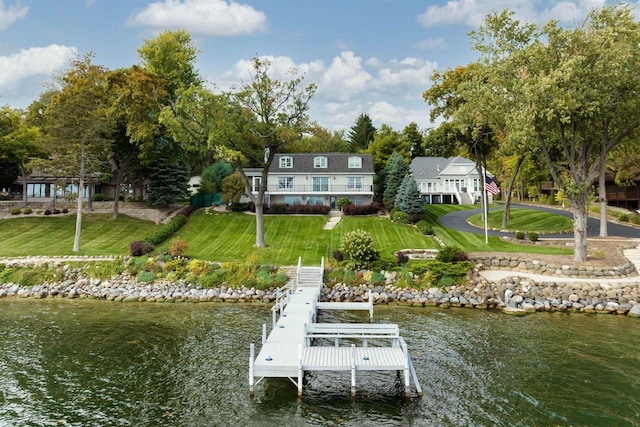 dock area with a yard and a water view