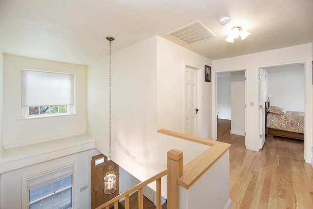 corridor with light hardwood / wood-style flooring