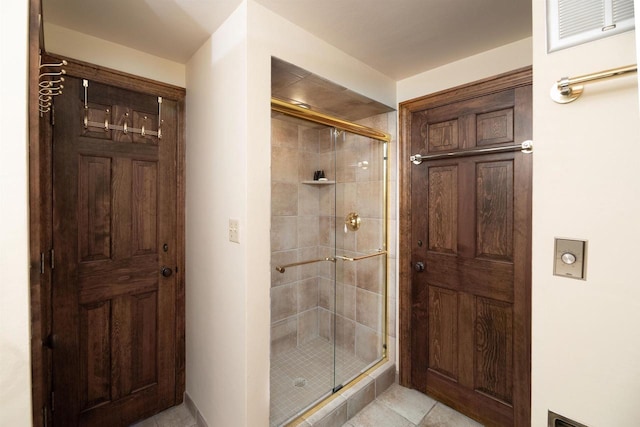 bathroom with tile patterned floors and an enclosed shower