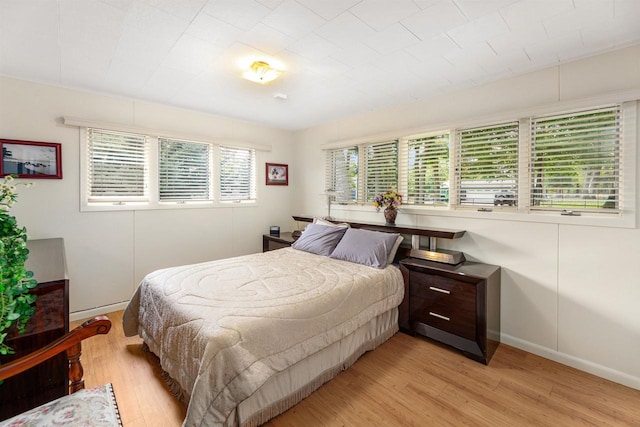 bedroom with light hardwood / wood-style floors