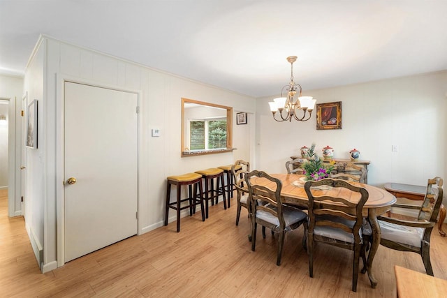 dining room featuring an inviting chandelier and light hardwood / wood-style flooring