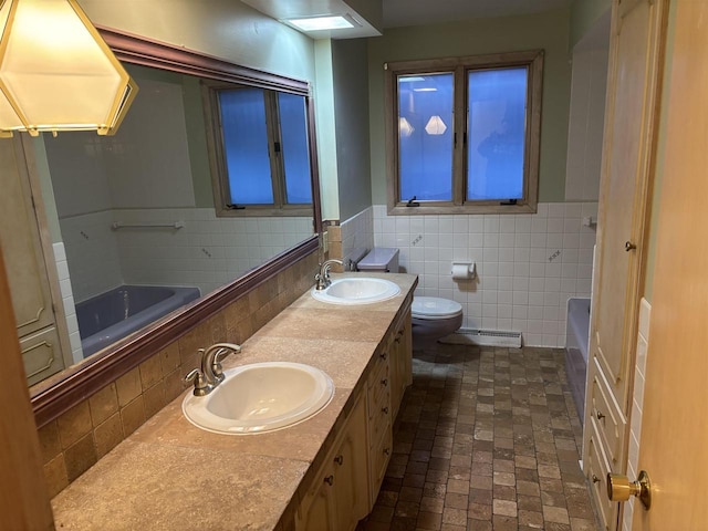 bathroom with a tub to relax in, tile walls, tasteful backsplash, toilet, and vanity