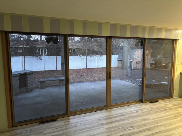 entryway with hardwood / wood-style flooring and a healthy amount of sunlight