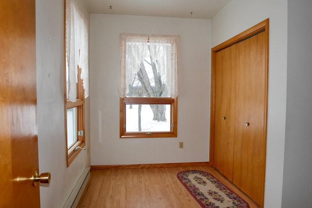 interior space with baseboard heating and light hardwood / wood-style flooring