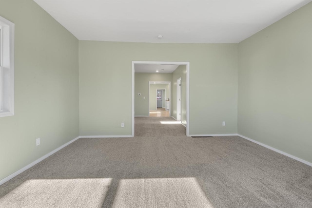 unfurnished room with light carpet