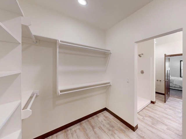 spacious closet featuring light hardwood / wood-style floors