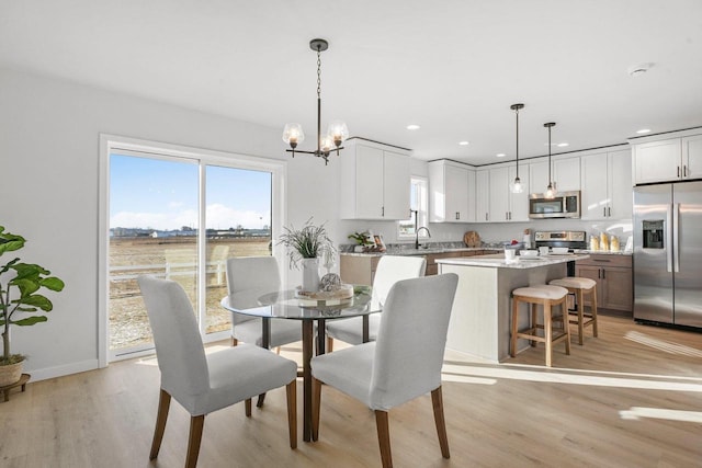 dining room featuring light hardwood / wood-style floors and an inviting chandelier