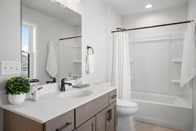 full bathroom with toilet, vanity, and shower / tub combo