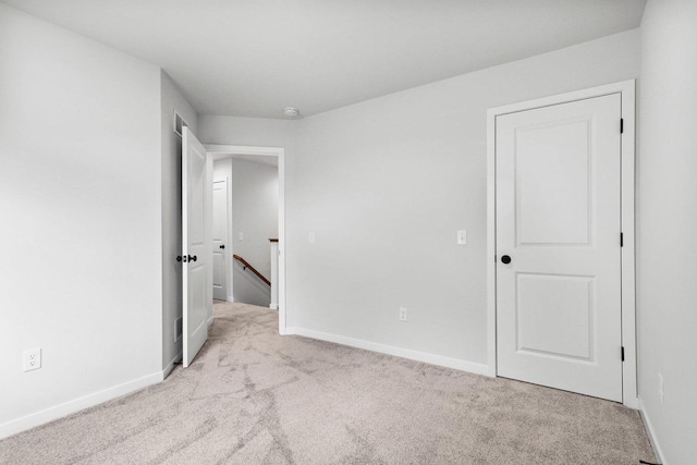 unfurnished bedroom featuring light colored carpet