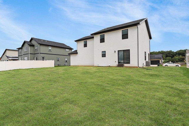 rear view of house featuring a lawn