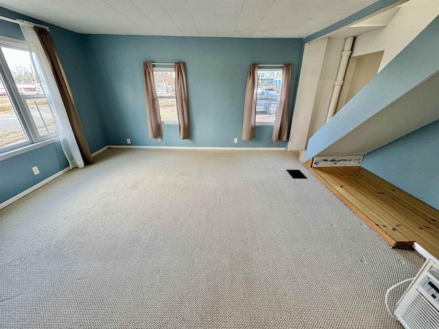 carpeted spare room featuring plenty of natural light