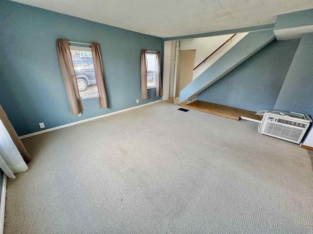 interior space featuring carpet and a wall mounted air conditioner