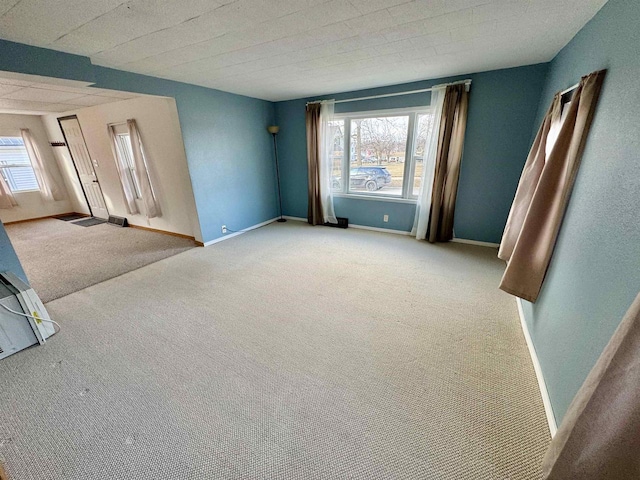 spare room with a wealth of natural light and carpet flooring