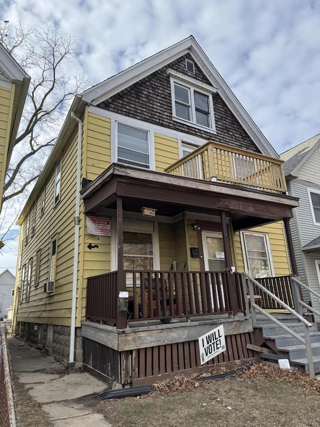 view of front facade featuring a balcony and covered porch