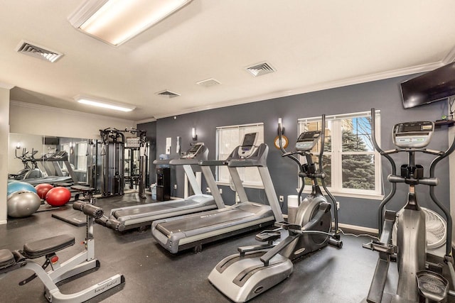 exercise room featuring crown molding