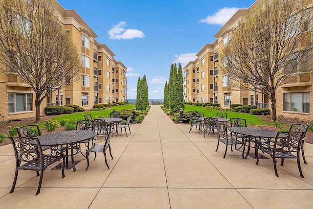 view of home's community featuring a patio area and a lawn