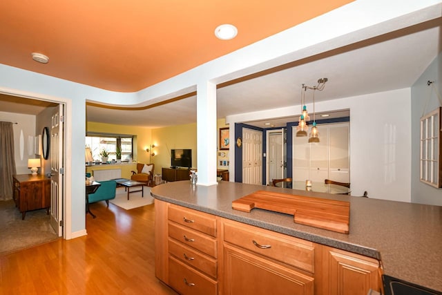 kitchen featuring decorative light fixtures and light hardwood / wood-style floors