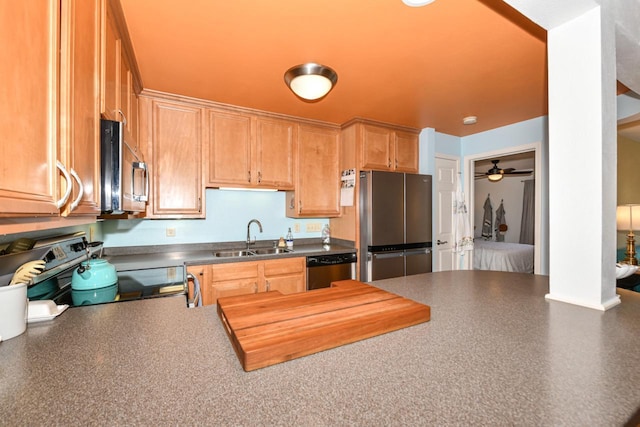 kitchen with ceiling fan, sink, and stainless steel appliances