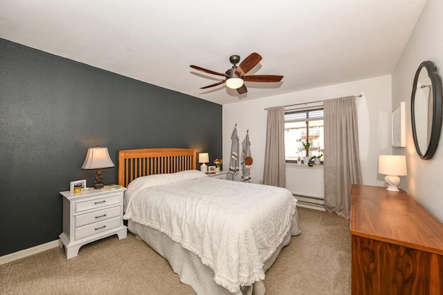 carpeted bedroom with ceiling fan and a baseboard heating unit