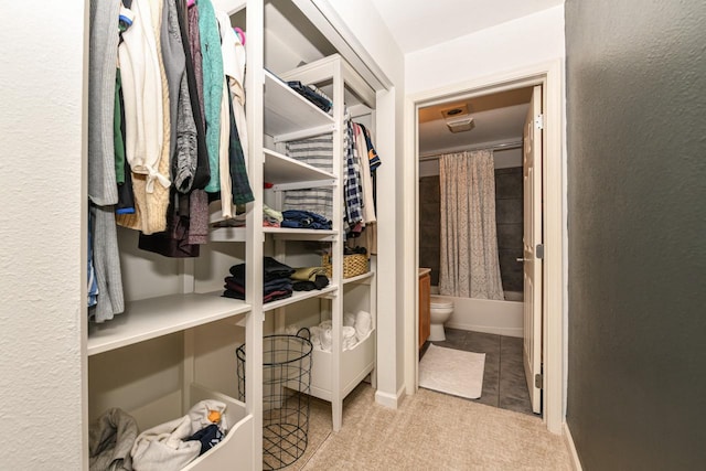 spacious closet featuring light carpet