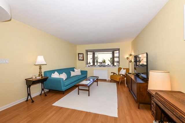 living room featuring light hardwood / wood-style floors and radiator heating unit