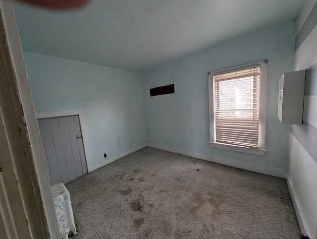 unfurnished room featuring light carpet