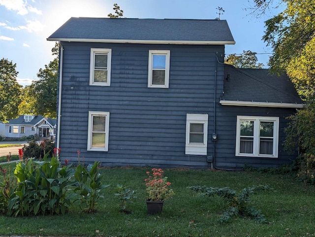 view of side of home with a yard