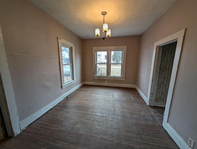 unfurnished dining area with dark wood-type flooring