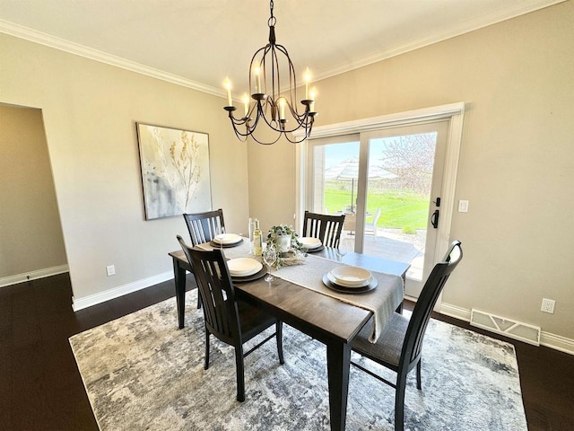 dining area with a notable chandelier, crown molding, and dark hardwood / wood-style floors