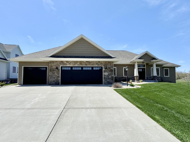 view of front of property with a front yard and a garage