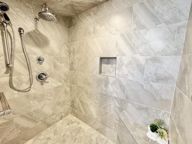 bathroom with a tile shower