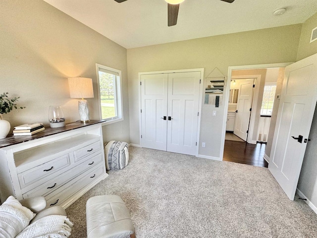 living area featuring dark colored carpet and ceiling fan