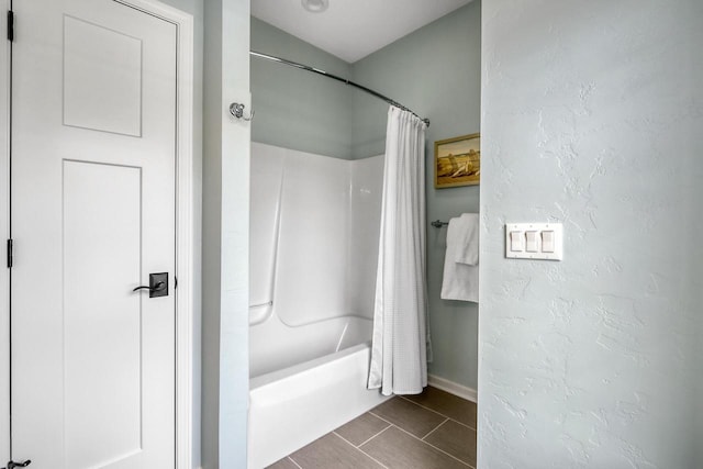 bathroom featuring tile patterned flooring and shower / tub combo with curtain