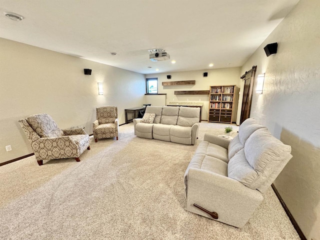 carpeted home theater featuring a barn door