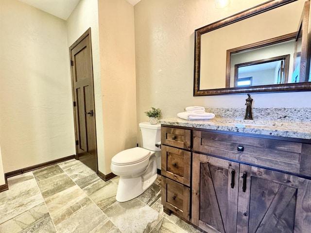 bathroom featuring toilet and vanity