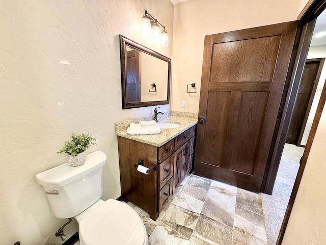 bathroom with toilet and vanity