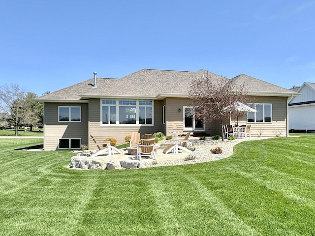 rear view of property featuring a patio area, a lawn, and a fire pit