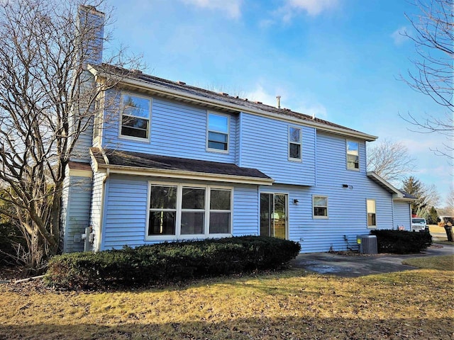 back of house with a patio area and central AC