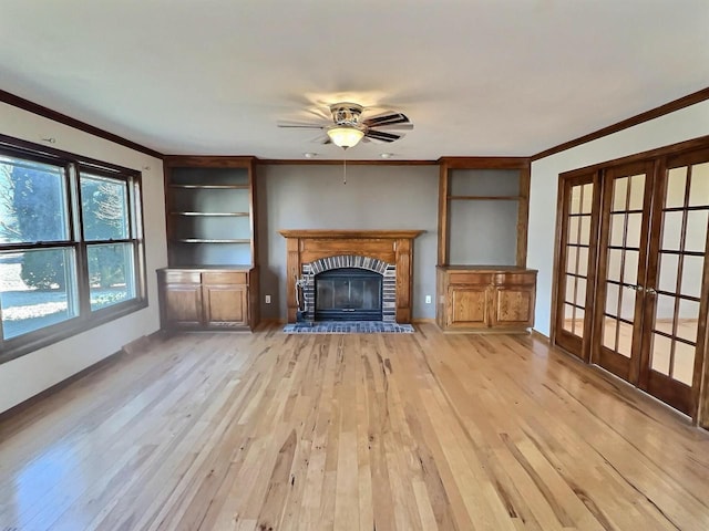 unfurnished living room featuring crown molding, light wood-type flooring, and ceiling fan