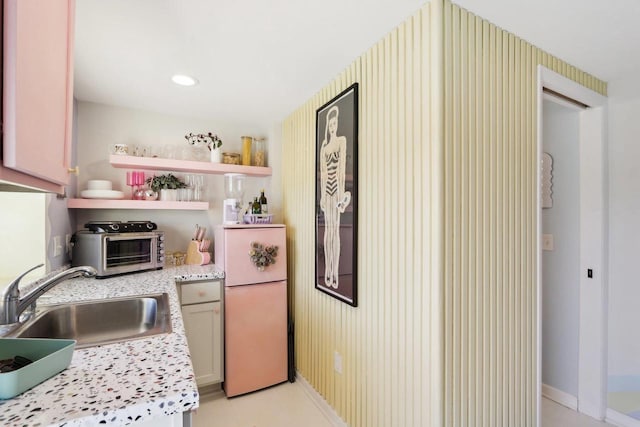 kitchen featuring fridge and sink