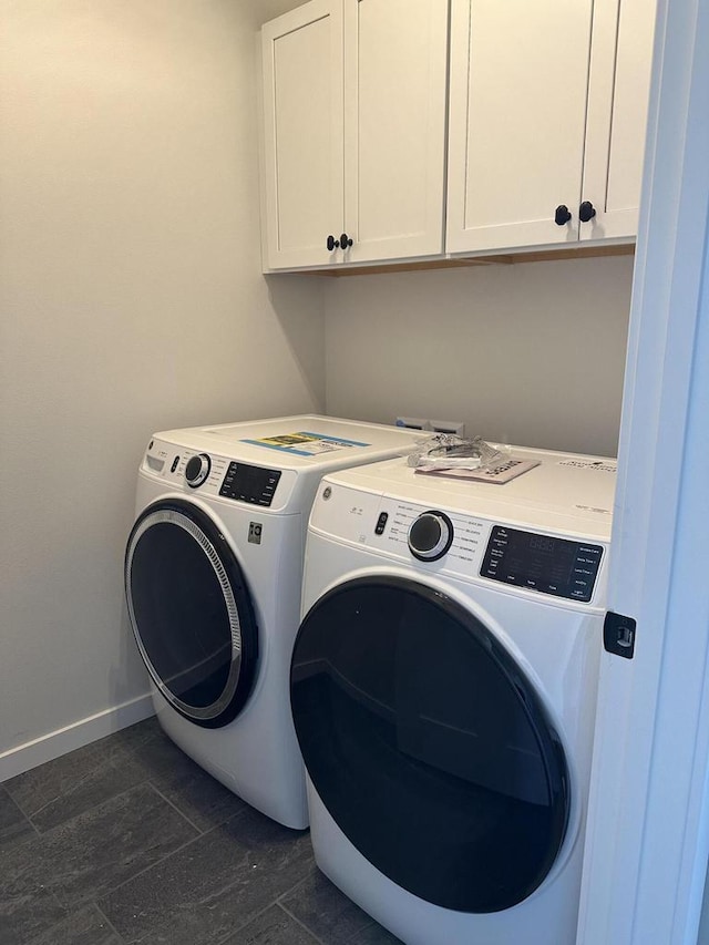 laundry area featuring cabinets and separate washer and dryer