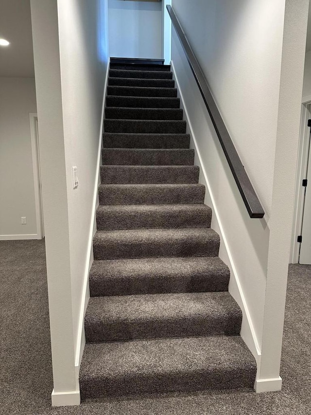 stairs featuring carpet