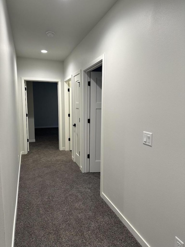 hallway with dark carpet